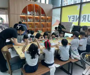 Joyful expressions on children’s faces as they create art during school workshop in Singapore