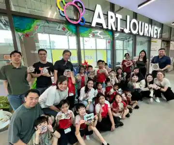 School children having fun creating colorful artwork in a guided art workshop