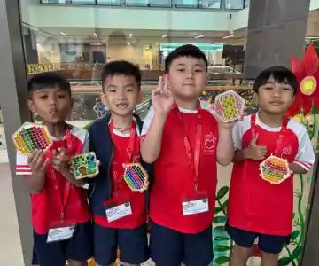 Proud kids showing their completed paintings during an art jamming class