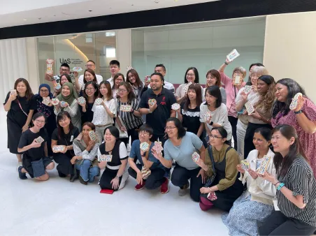 Seniors painting together during friendly art workshop session