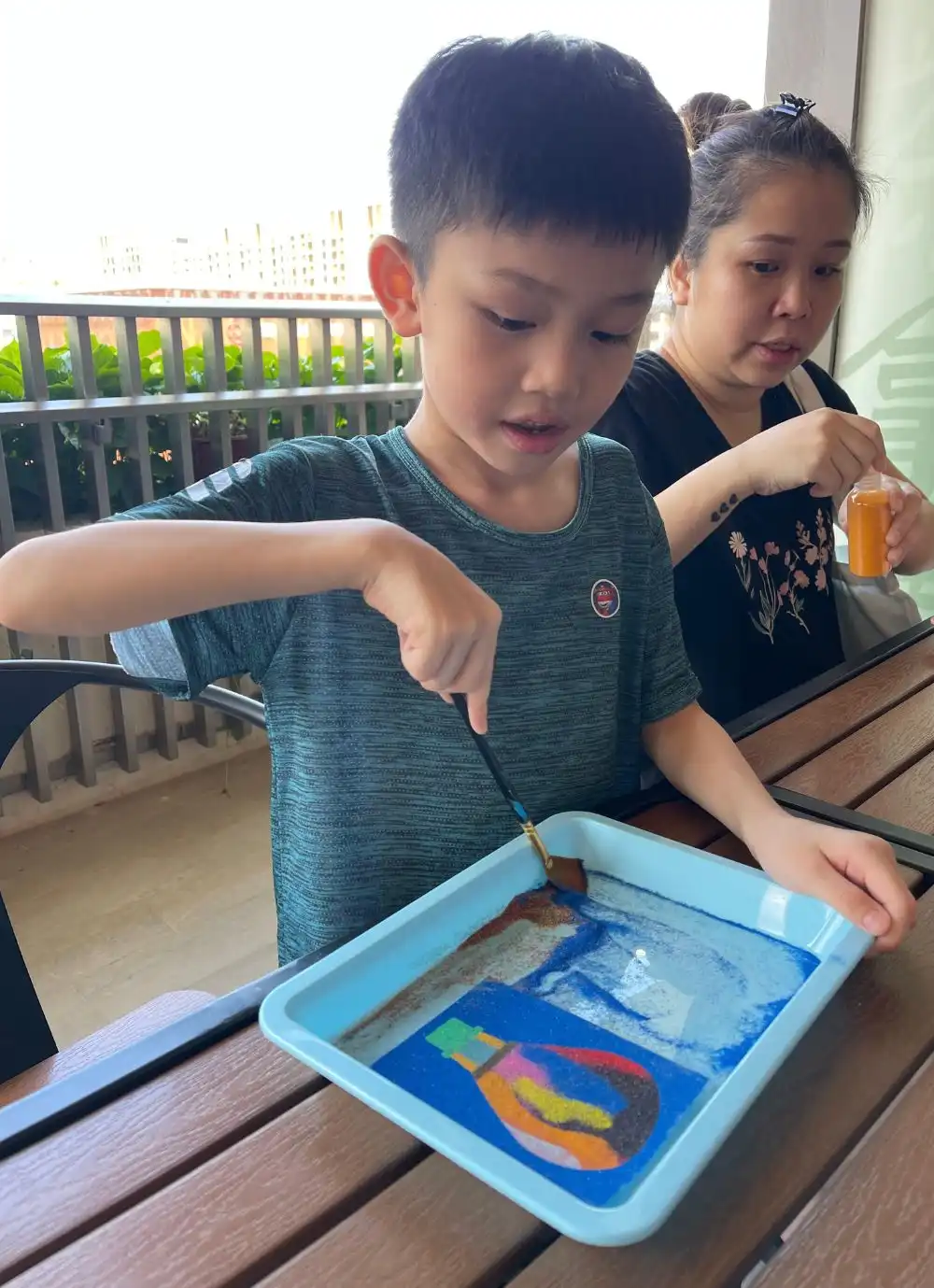 Bright and clean studio space set up for children’s sand art activities.