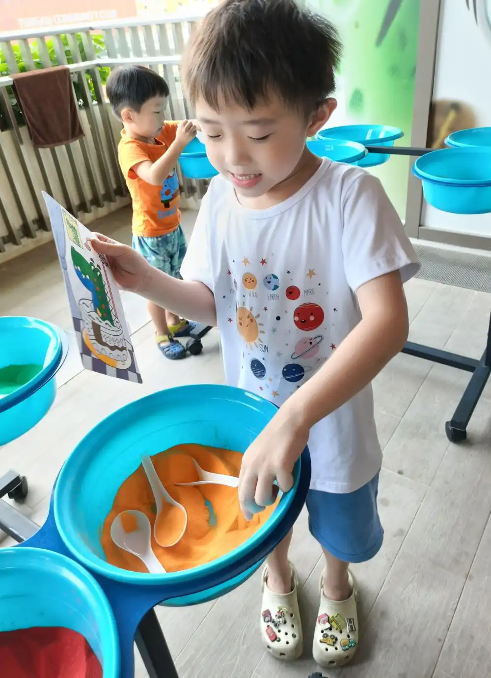 Colourful sand bottles and templates prepared for a kids sand art workshop.