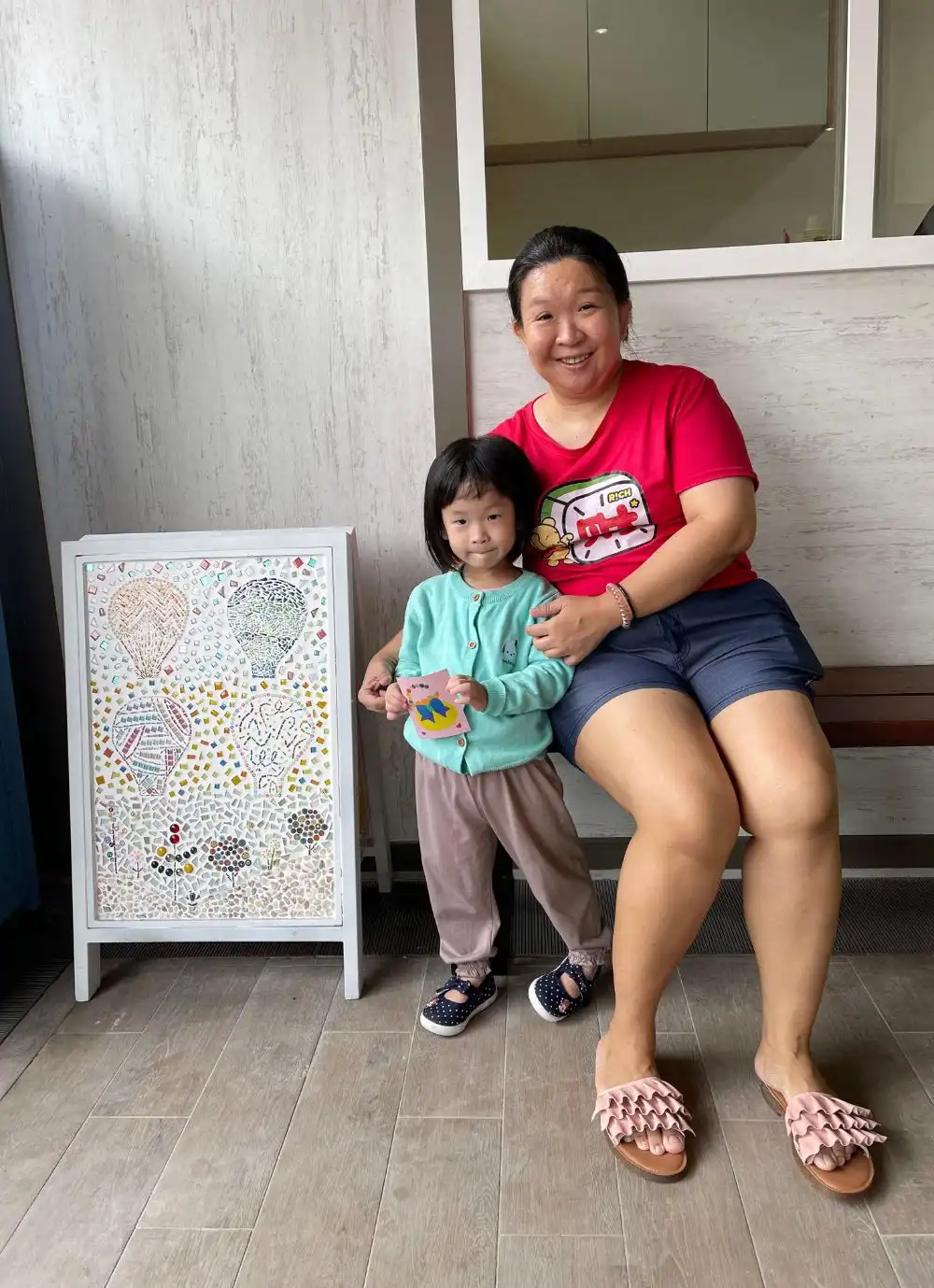 Happy children proudly displaying their finished sand art creations.