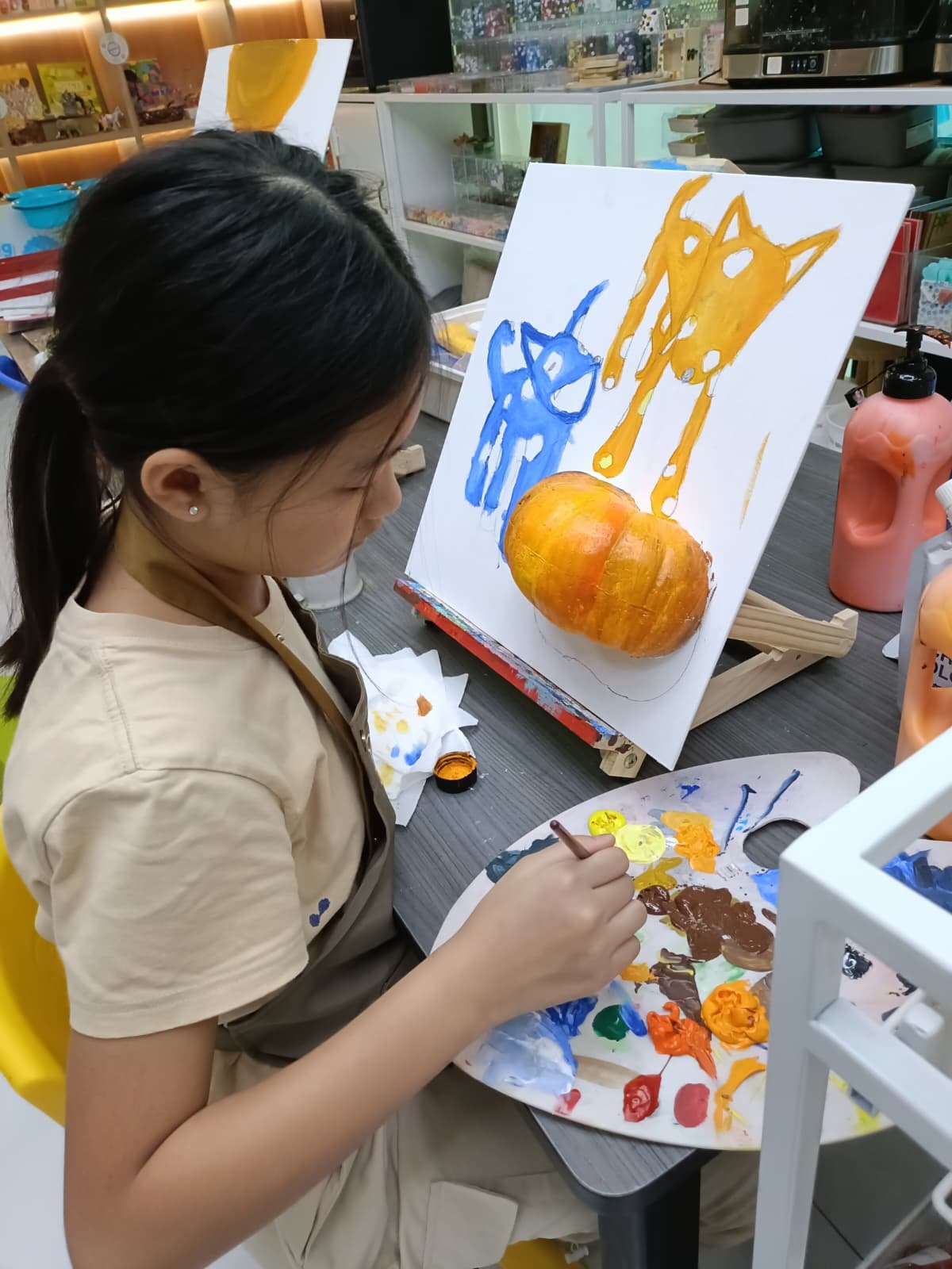 Colourful framed cat painting created by a child during an art workshop at Art Journey Singapore