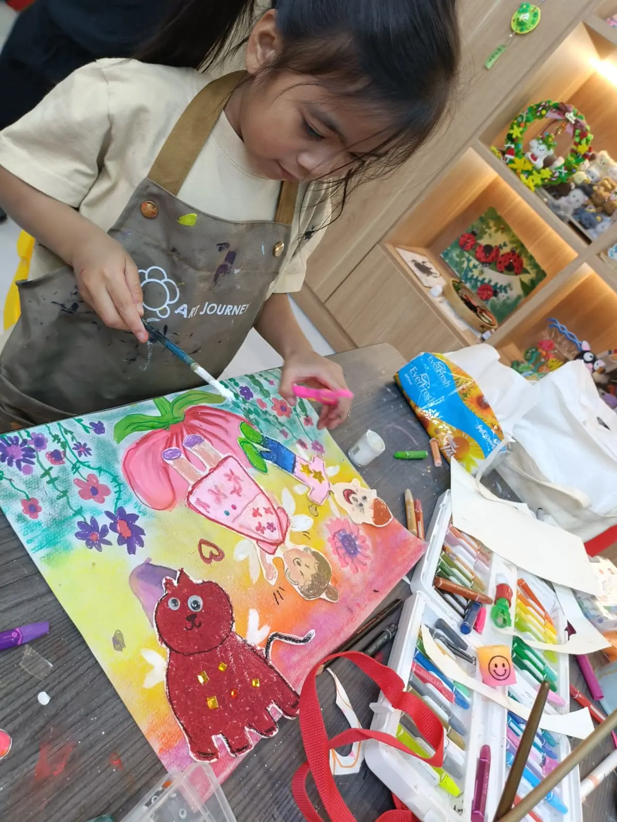 3-year-old child happily exploring paint during an art session at Art Journey Singapore