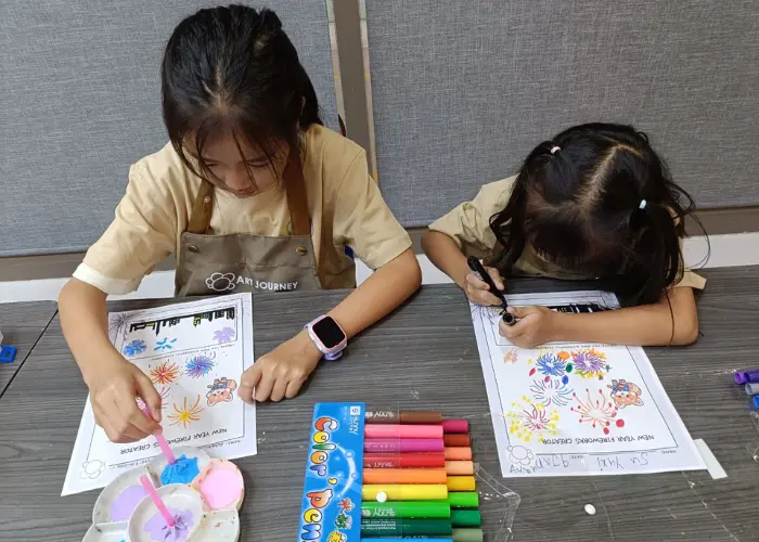 Children creating art with simple materials during a creative session at Art Journey Singapore