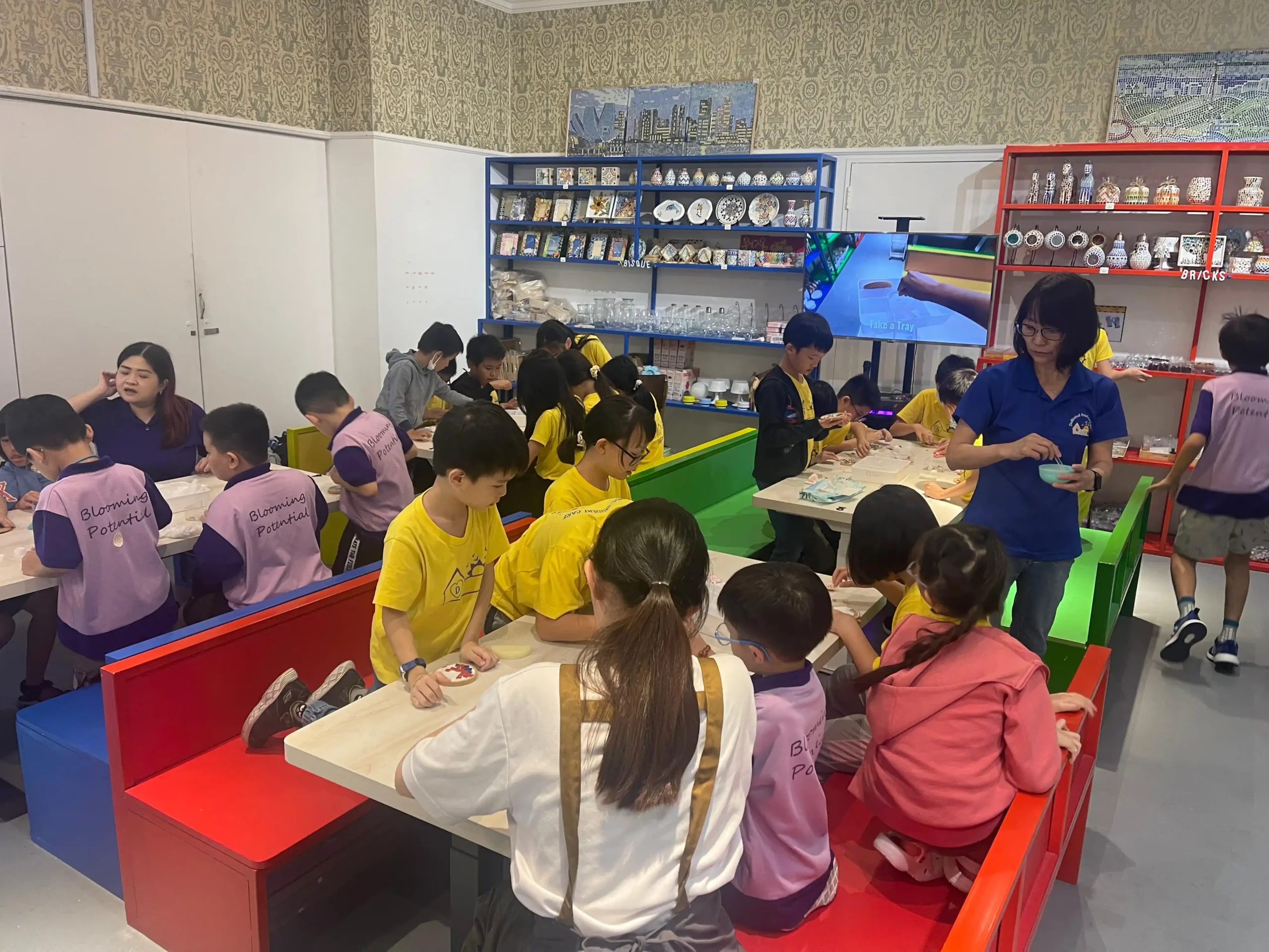 Children creating art during a June school holiday workshop at Art Journey Singapore