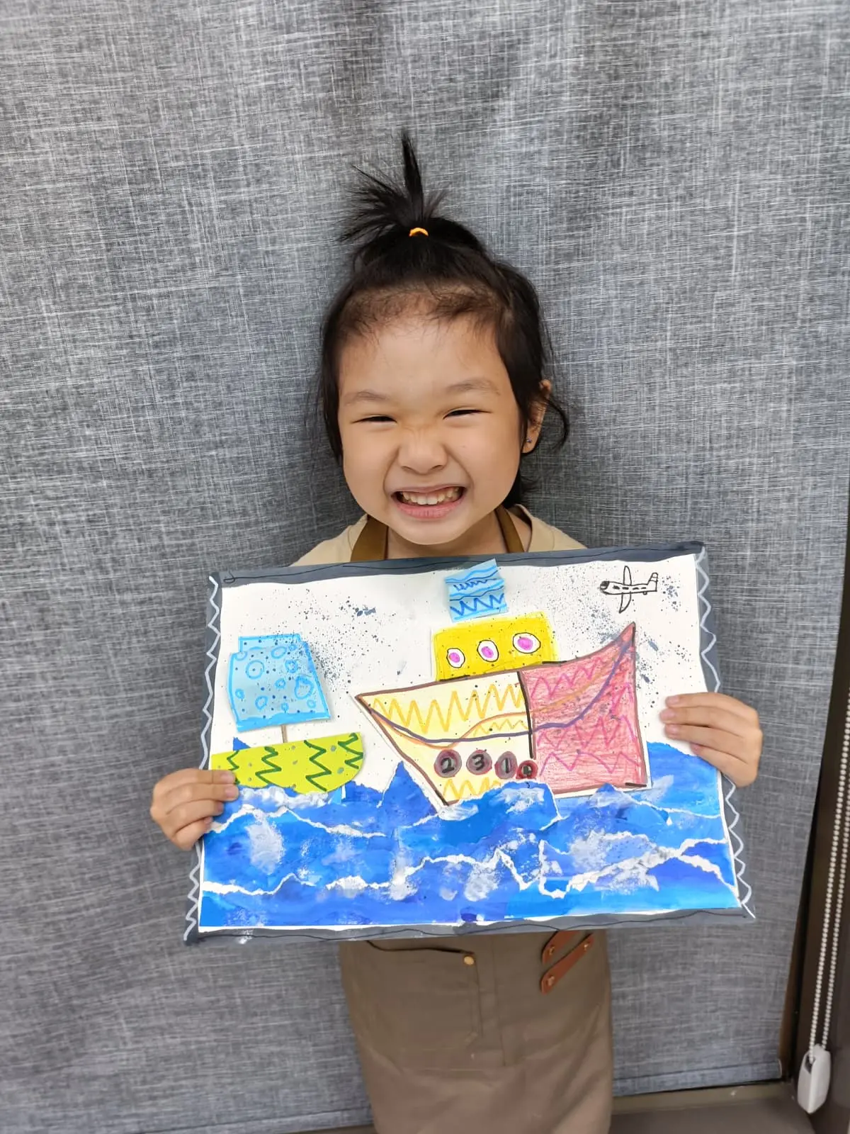 Children proudly showing their completed artworks from an Art Journey creative workshop in Singapore