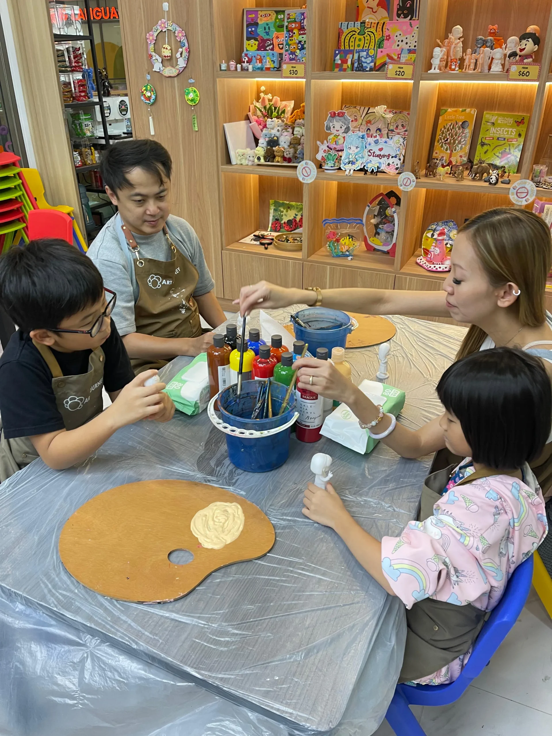 Family enjoying a creative art jamming session together at Art Journey Singapore during a long weekend