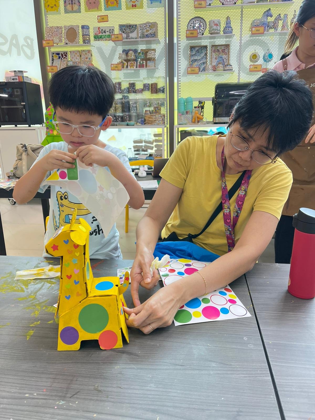 Mother and child creating art together during a family art jamming session at Art Journey Singapore
