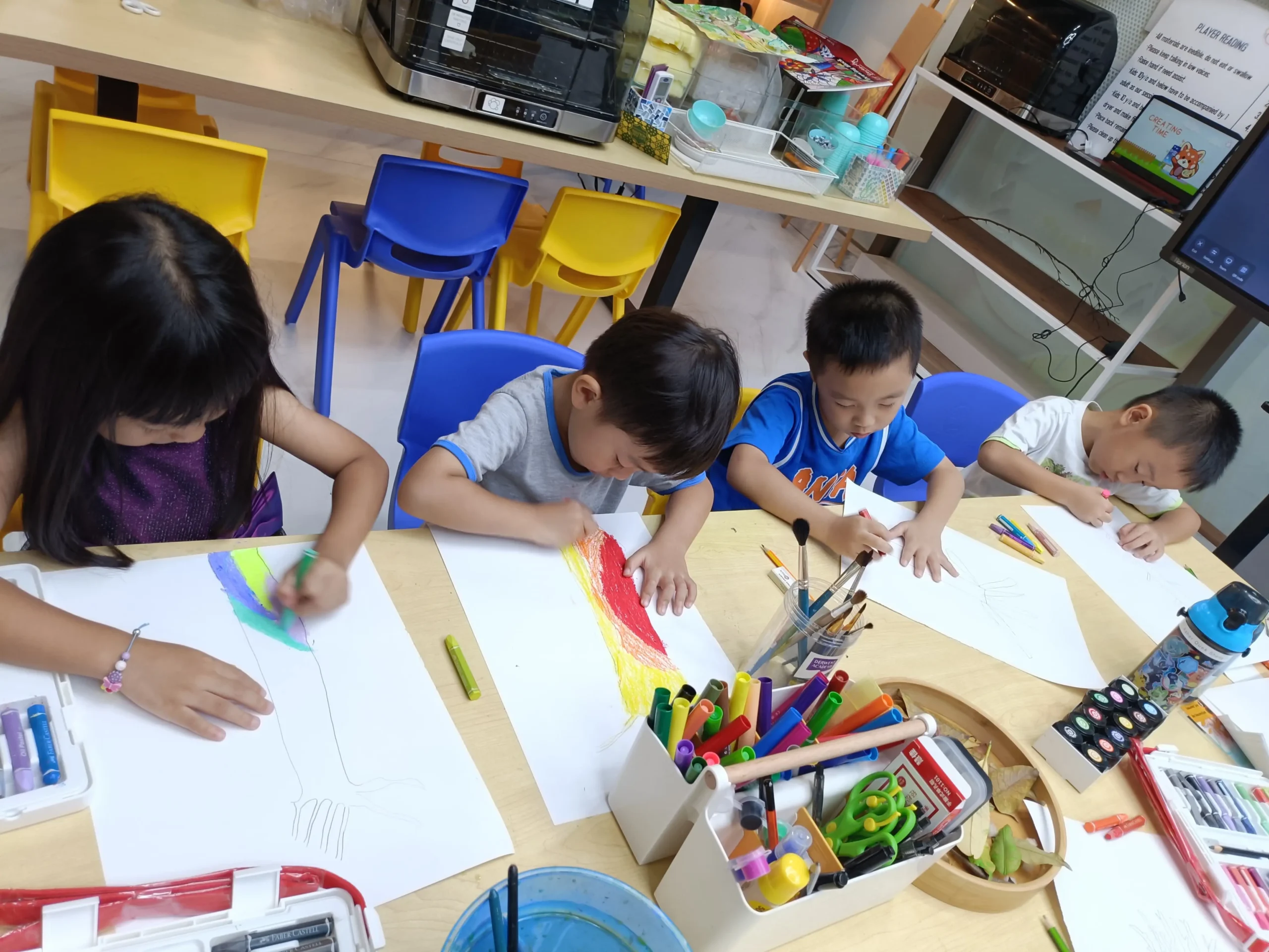 Primary school child focused on painting a canvas during an Art Journey Singapore workshop