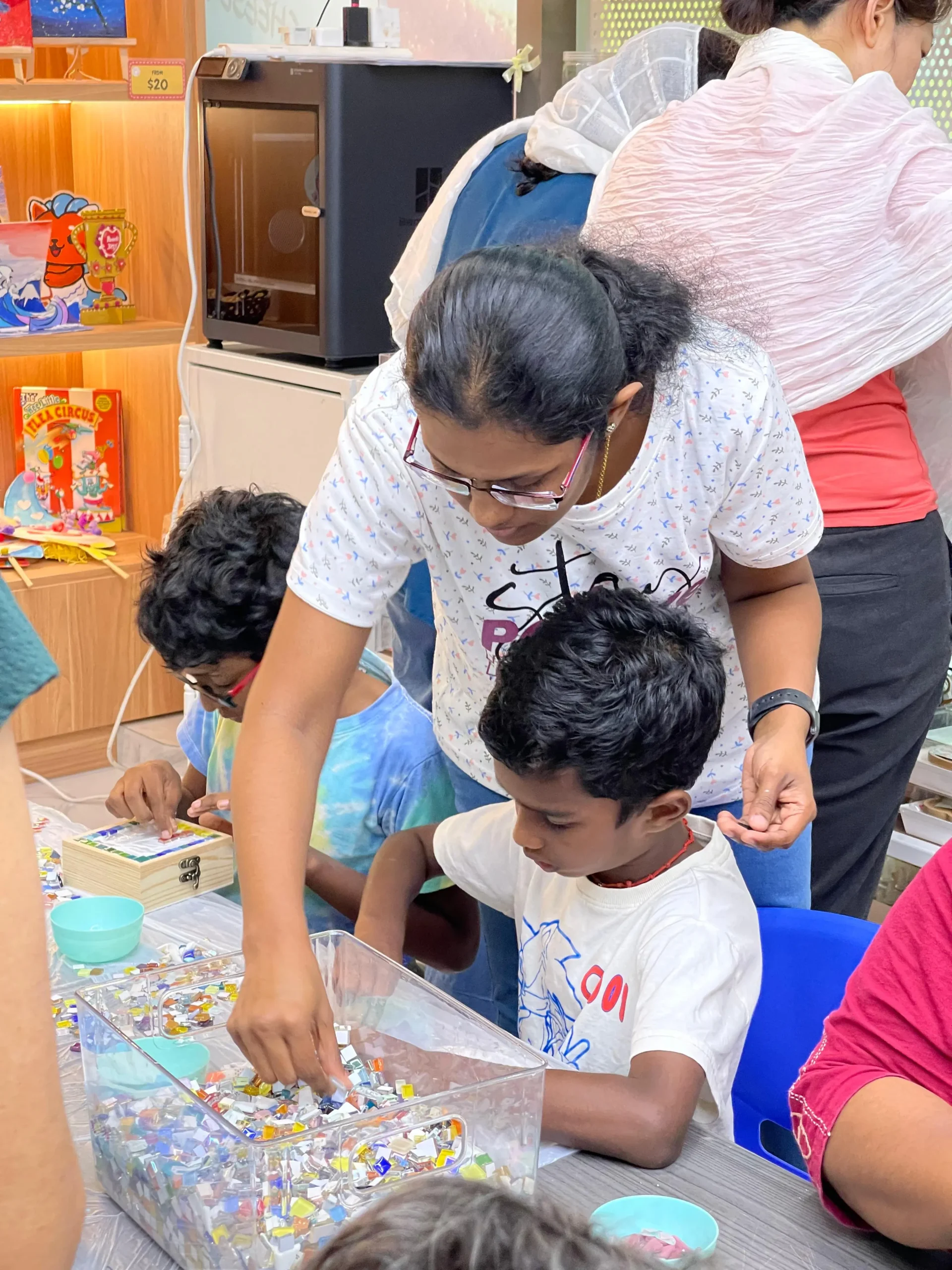 Young child with parent exploring art materials during a family art jamming session at Art Journey Singapore