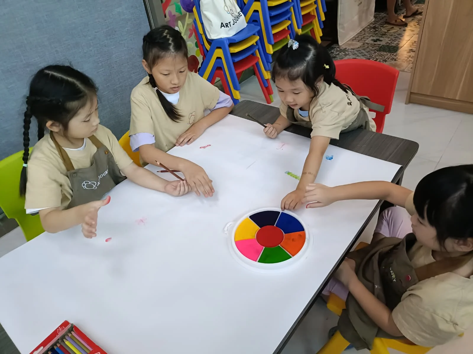 Young children aged 4-6 working on creative art projects during an Art Journey workshop session in Singapore