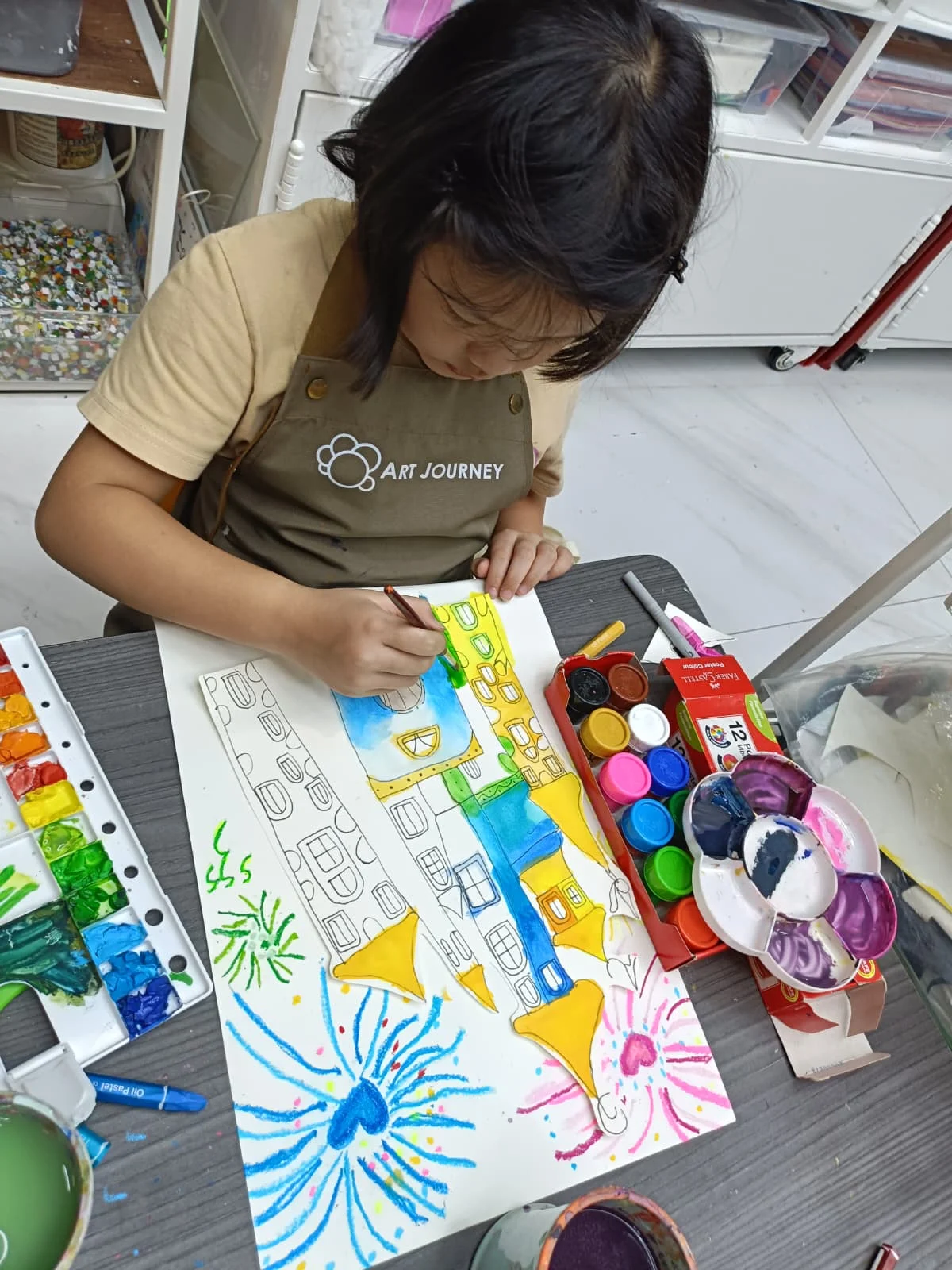 Child deeply focused on painting during an art workshop at Art Journey Singapore