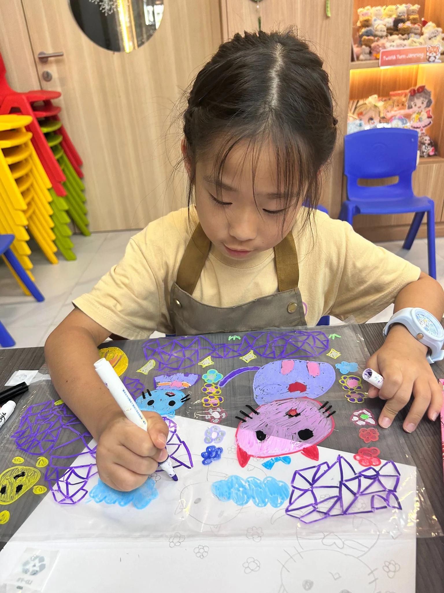 Child happily creating art at home during the school holidays using simple household materials