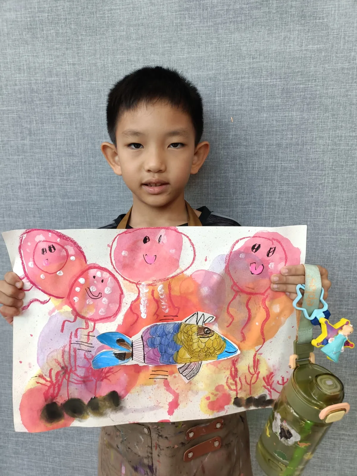 Child proudly showing a completed artwork to family during a creative celebration