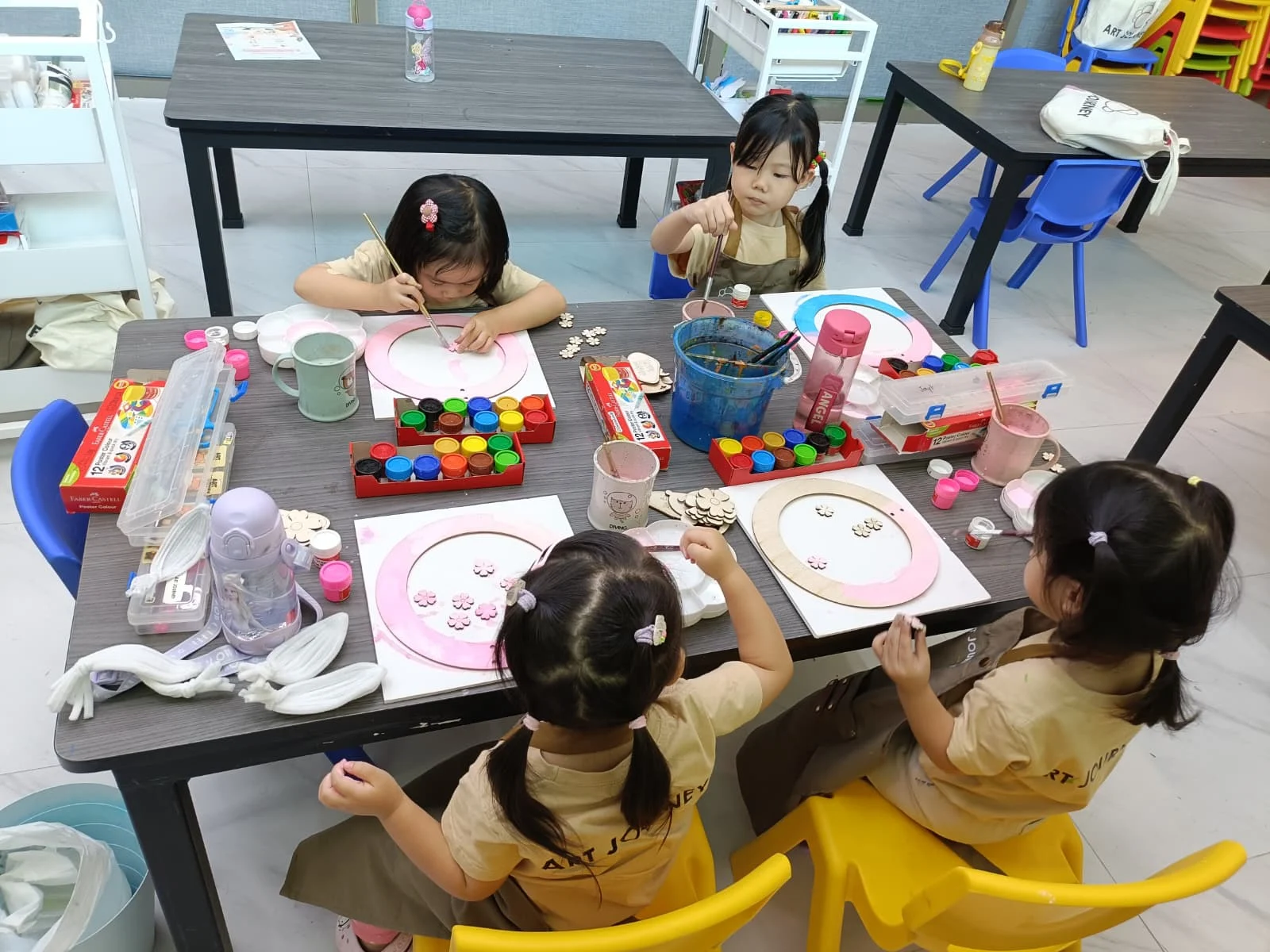 Children creating heritage-inspired artwork during a multicultural creative workshop at Art Journey Singapore