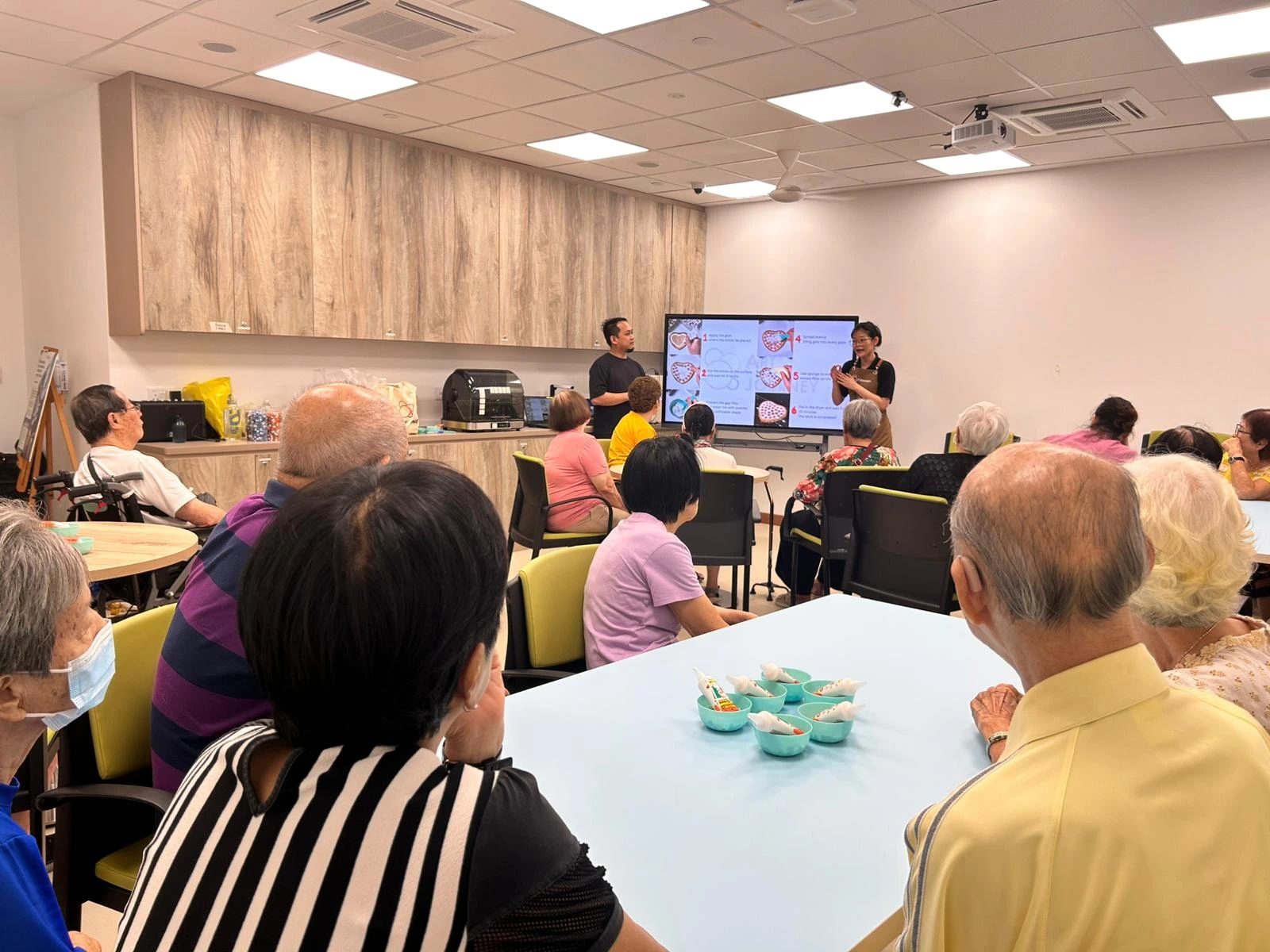 Group of seniors happily creating art together during a creative workshop at Art Journey Singapore