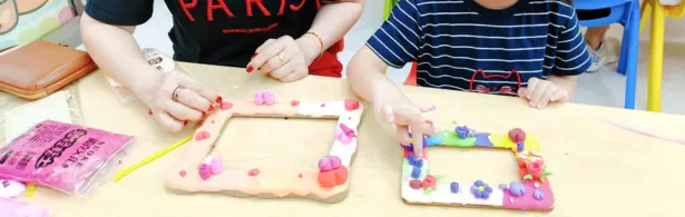 Preschooler shaping a small clay sculpture at Art Journey Singapore