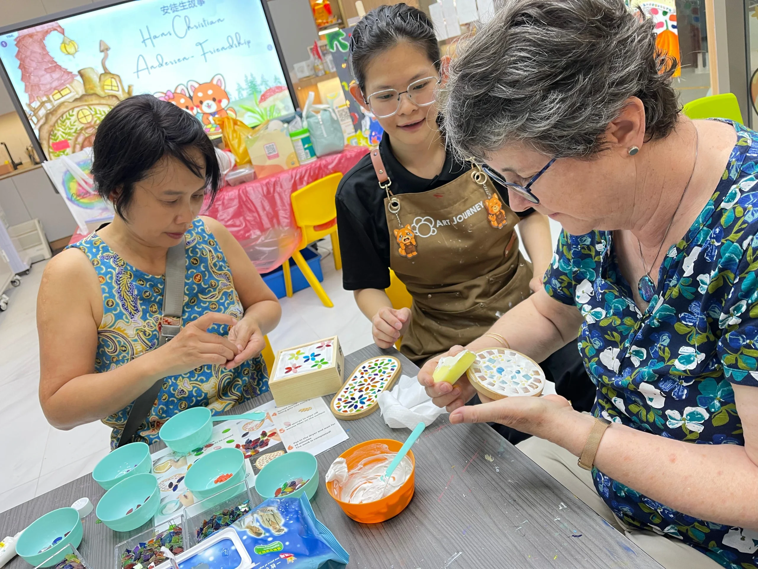 Senior creating a mosaic artwork during a hands-on workshop at Art Journey Singapore