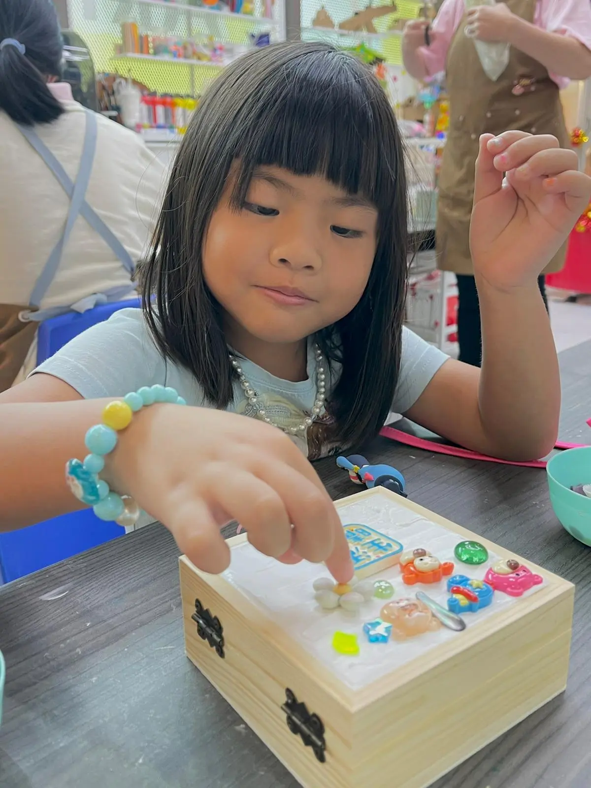 Child arranging mosaic pieces
