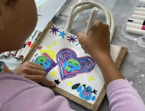Child hand painting at Art Journey