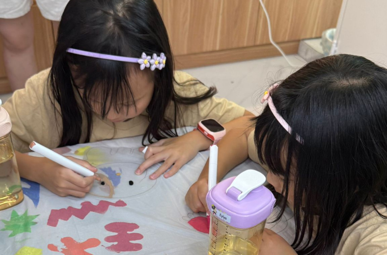 Preschooler holding a brush with proper tripod grip