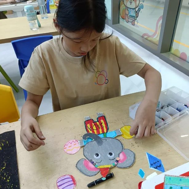 Young artist creating during june holiday art class at Art Journey Singapore