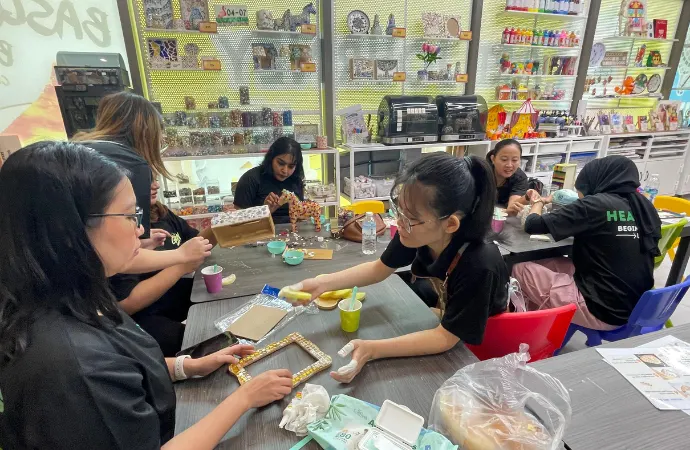 Adult working on an intricate mosaic art piece at Art Journey Singapore