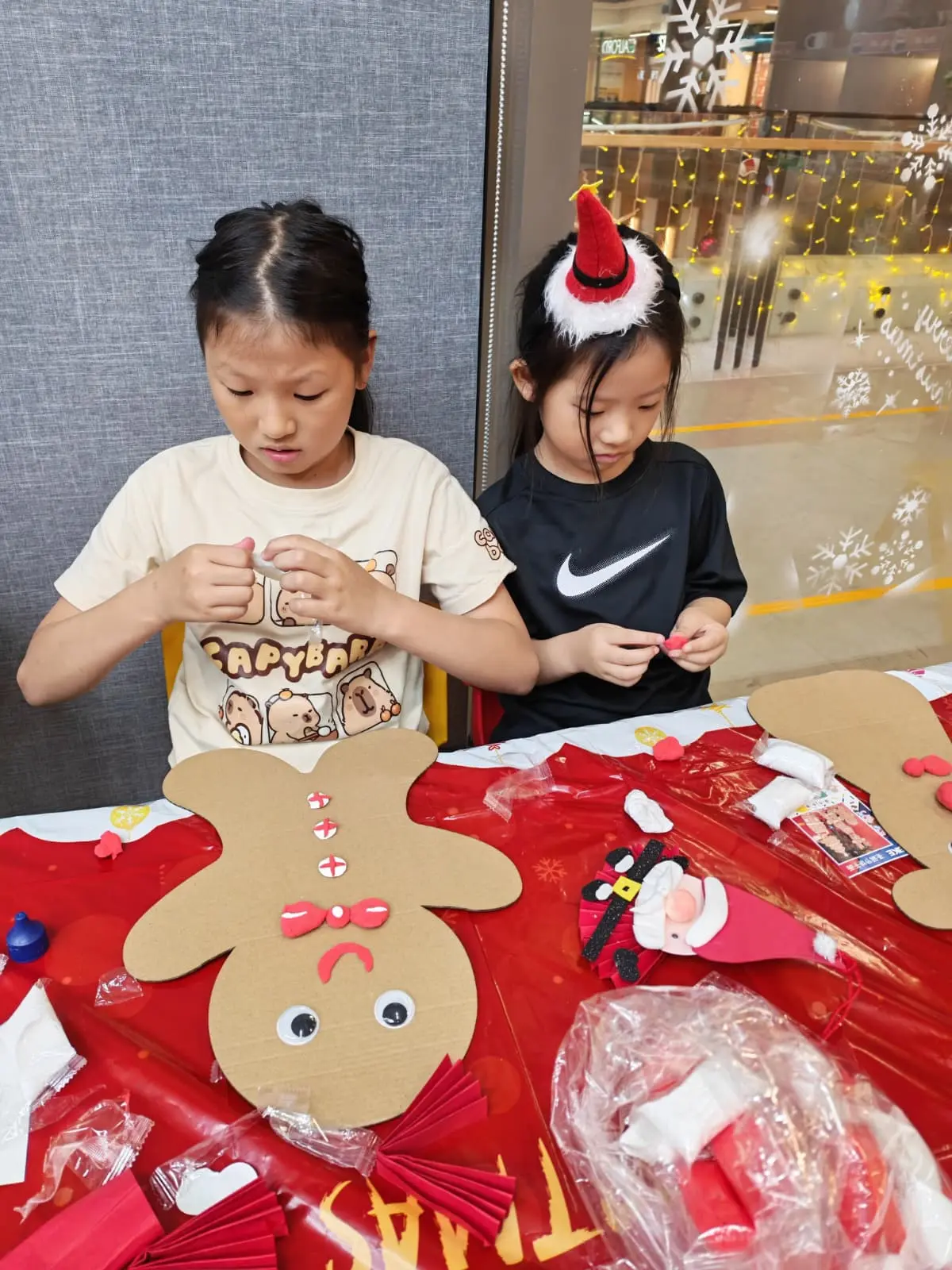 Child creating a handmade Christmas gift during a festive art workshop at Art Journey Singapore