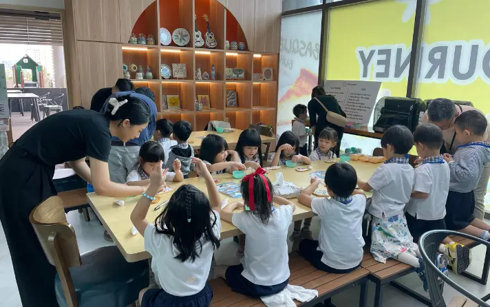 Children at the Art Journey Holiday Art Camp Singapore, creating projects at easels in the Tengah studio