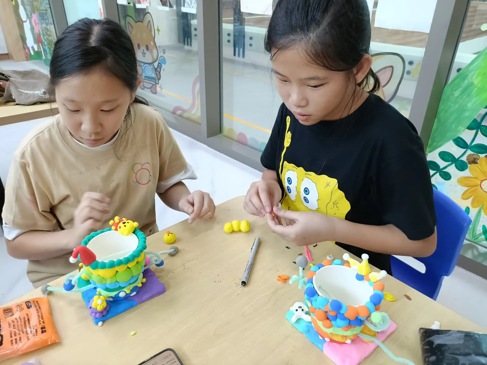 Children exploring different art materials during a mixed media creative workshop at Art Journey Singapore