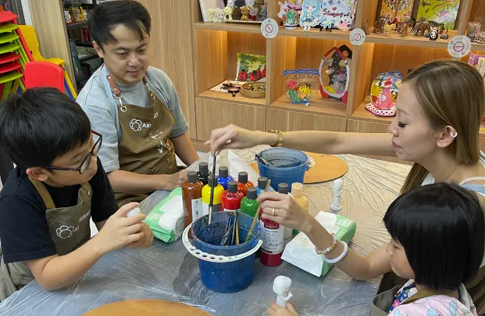 Family of four enjoying an art jamming session at Art Journey Singapore studio