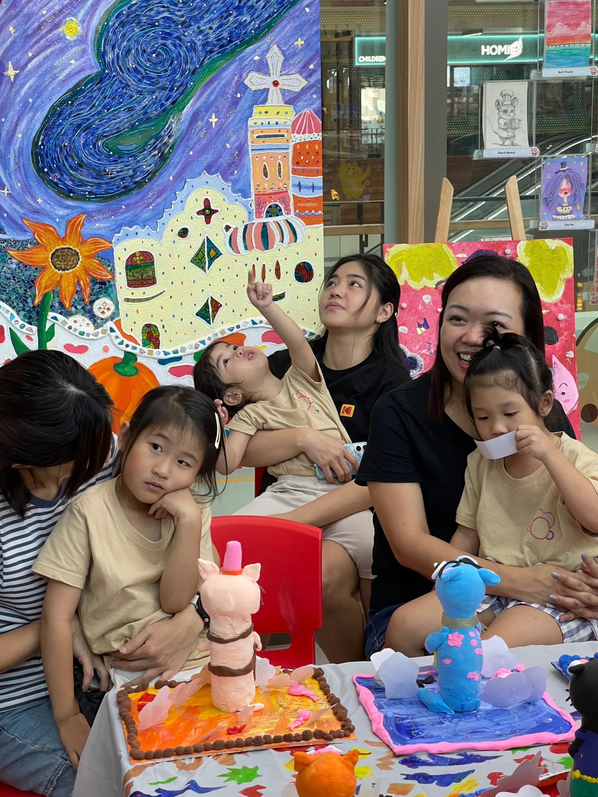 Family with children enjoying a drop-in creative art session together at Art Journey Singapore
