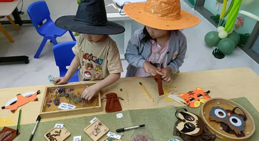 Preschooler closely observing a real object before drawing it at Art Journey Singapore