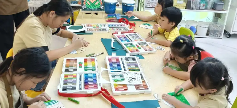 Young artist focused on detailed art project at Art Journey Singapore studio