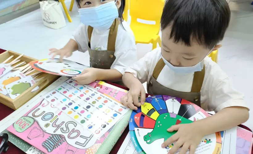 Child happily painting freely during an unstructured art session at Art Journey Singapore