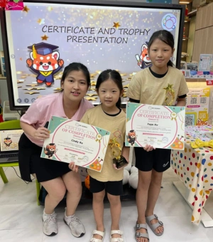 Young artists receiving certificate of completion and trophy at Art Journey kids art workshop in Singapore