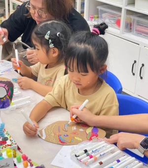 Young creators drawing with acrylic markers during a creative craft session at Art Journey kids art workshop