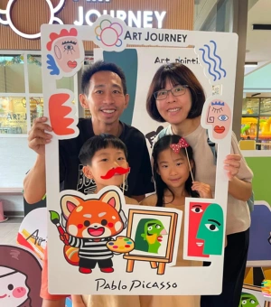 Family posing with the Art Journey Rumi photo frame at the studio in Singapore