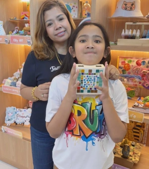 Mother and daughter holding a completed mosaic jewellery box at Art Journey Singapore