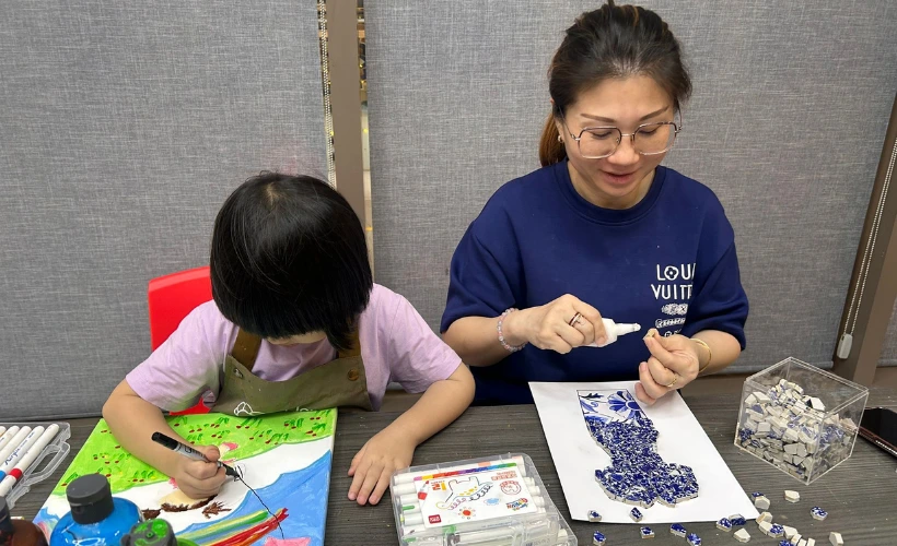 Parent and child creating art together at Art Journey Singapore on a relaxed weekday childcare leave day