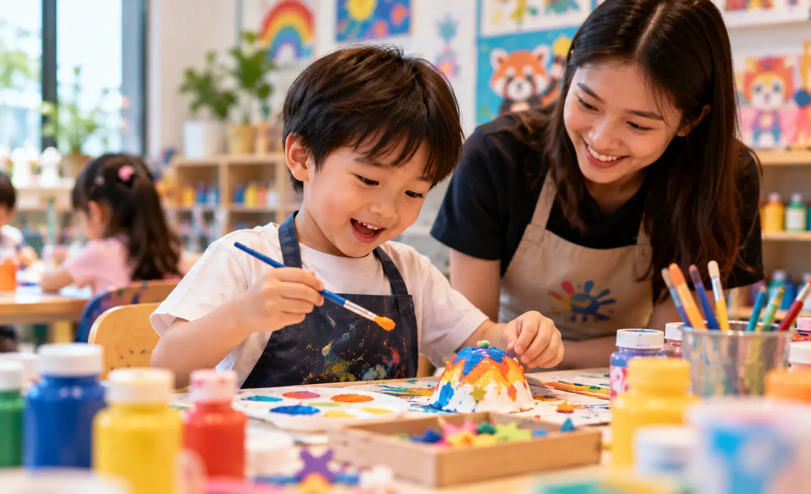 Child at Art Journey Singapore trying a creative activity for the first time with materials on the table