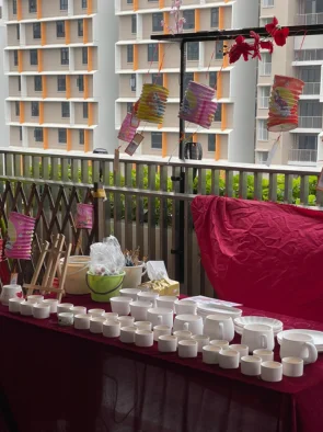 Table of blank ceramic cups mugs and plates at a ceramic painting singapore setup