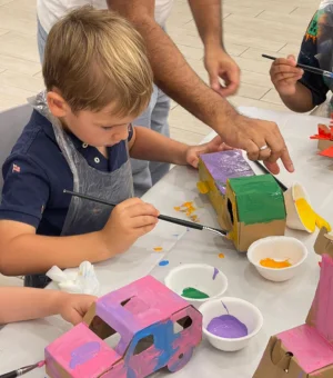 toddler-painting-cardboard-vehicle-workshop